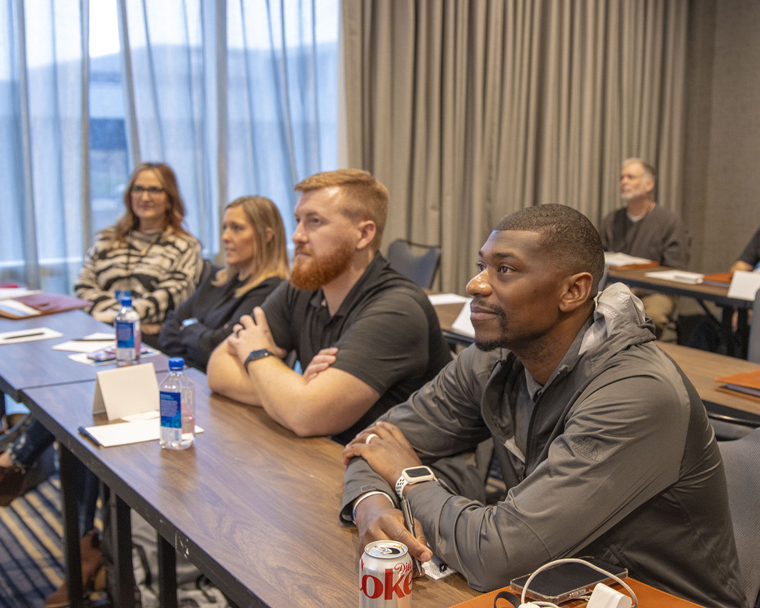 Team Members Listening to Presentations